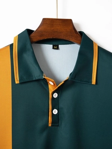 Detail of piqué fabric texture on dark green polo shirt with orange collar piping