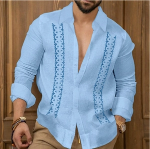 Detailed close-up of light blue men shirt with navy embroidery and cotton texture