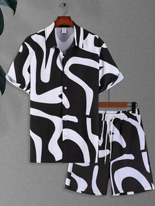 Detail of tropical palm print short sleeve shirt and shorts set on a hanger
