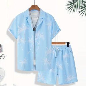 Close-up of sky blue summer set with tropical palm tree print on shirt and shorts