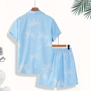 Close-up of men's blue summer set with white coconut tree prints and elastic waistband