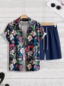 Close-up of tropical palm leaf pattern on casual navy blue shirt and shorts set