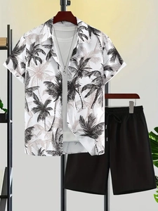 Detailed view of casual short-sleeved shirt with palm tree print and black shorts set