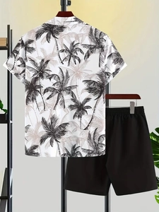 Detail of hanging summer set featuring tropical coconut tree print shirt and black shorts