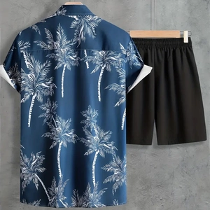 Detail of navy blue Hawaiian shirt with palm tree print and black elastic waist shorts
