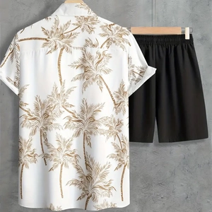 Detail view of summer beach set with palm tree print shirt and casual black shorts
