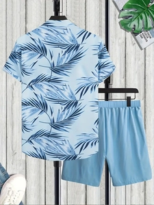 Detail of light blue short sleeve shirt with palm tree print and elastic shorts set