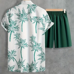 Close-up of tropical palm leaf print on white shirt and matching green summer shorts