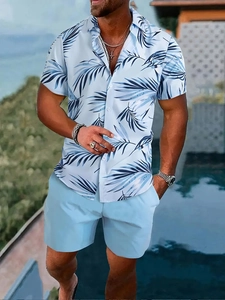Detailed view of the button-up short sleeve shirt featuring blue palm tree prints on white