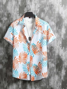 Close-up of tropical palm leaf print on short sleeve shirt with button-down collar