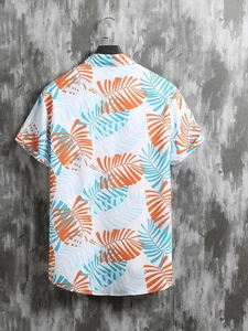Back view of a white tropical short sleeve shirt with palm tree prints on a hanger