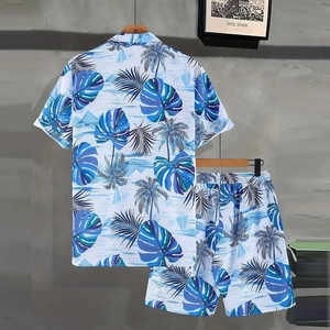 Detail of summer Hawaiian set with tropical palm and sailboat print on shirt and shorts