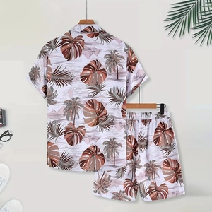 Detailed macro view of men's summer vacation set with tropical palm leaf digital prints