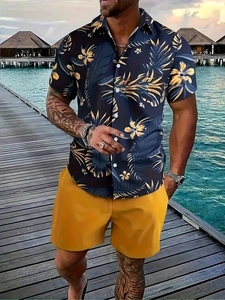 Detail of men's summer vacation outfit featuring palm tree print shirt and yellow shorts