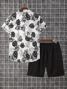 Detail of men's tropical palm leaf shirt and casual black shorts set on hanger