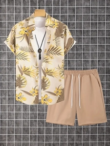 Detailed close-up of tropical palm leaf print on beige short sleeve shirt and khaki shorts set