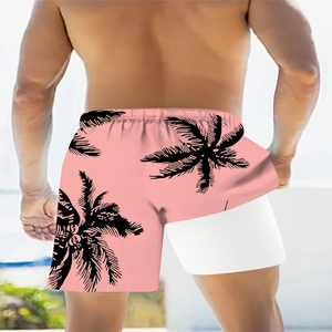 Detail view of pink beach shorts with black palm leaf prints and white liner