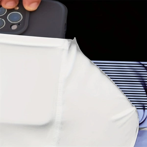 Close-up of white microfiber cleaning cloth wiping a dark smartphone screen