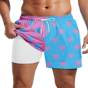 Detail of 2-in-1 beach shorts with contrasting palm tree print and white inner liner