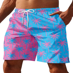 Detail of Hawaiian swim shorts with pink and blue colorblock and palm tree print
