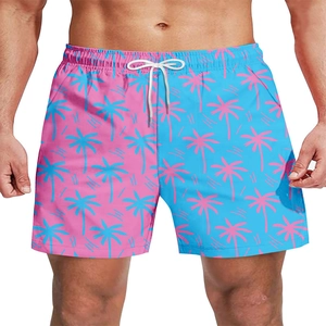 Detail of men's quick-dry beach shorts with pink palm prints and blue-pink split design