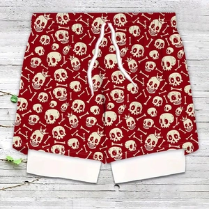 Detail of red swim trunks featuring beige skull prints and adjustable white drawstring waist