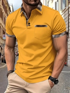 Detail of ginger yellow polo shirt with brown checkered collar and sleeve accents