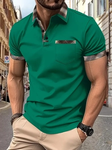 Detail of green men's Polo shirt with brown plaid collar and pocket on city street