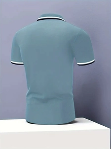 Detail of greyish blue slim fit Polo shirt with black and white striped ribbed cuffs