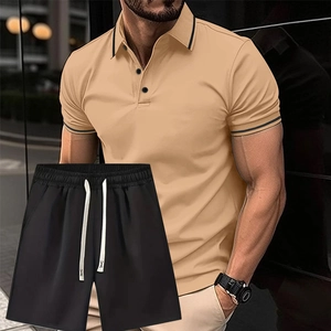 Dettaglio della polo kaki con bordi a contrasto e pantaloncini neri con coulisse bianca