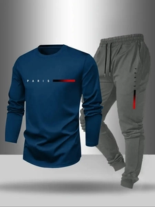 Detail view of navy long-sleeve tee and grey joggers with Paris print and gradient stripes