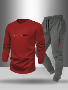 Detail of red long-sleeve T-shirt and grey joggers with Paris letter print on the side