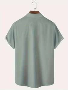 Back view of men's sage green short sleeve shirt on a wooden hanger with curved hem