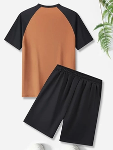 Flat lay of men's two-piece sports set with raglan sleeve t-shirt and elastic shorts