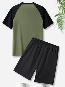 Flat lay of men's raglan sleeve t-shirt and elastic shorts in green and black