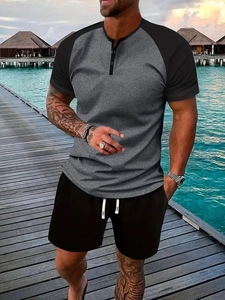 Close-up of men's summer Henley shirt with contrast raglan sleeves and drawstring shorts