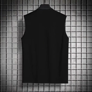 Rear view of men's black sleeveless fitness tank top hanging on a metal mesh wall