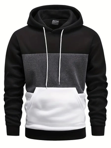 Detail of hooded sweatshirt featuring color block panels and kangaroo pocket