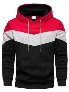 Detail of tricolor oversized hoodie featuring red, grey, and black patchwork design