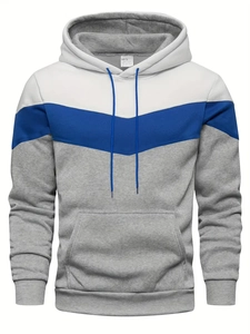 Close-up of color-block hoodie featuring white, blue, and gray V-pattern design