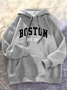 Detail of grey Boston hooded sweatshirt with kangaroo pocket on a vintage background