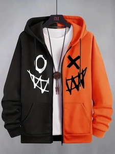 Detail of hooded jacket with orange and black color block and graffiti print