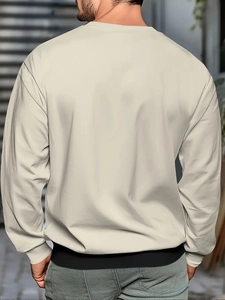 Gros plan du sweat-shirt beige à col rond montrant les coutures tombantes et le tissu premium