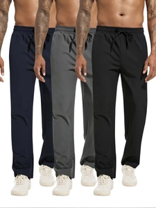 Close-up of men's casual joggers in navy blue, charcoal grey, and black colors