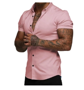 Detail of slim fit pink short sleeve shirt featuring contrasting black buttons and lapel