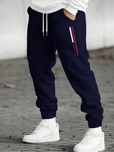 Detail of navy jogger pants with NAUTICAL letter print and drawstring waist