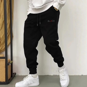 Men's black casual joggers with drawstring waist and red 'BLACK' graphic print detail