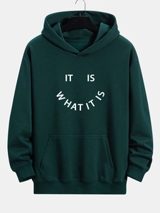 Detail view of dark green hoodie featuring white smile text print and ribbed cuffs