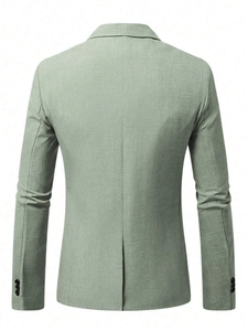 Detail of mint green slim fit blazer showing the linen texture and back center vent