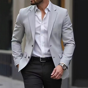 Detail view of light grey slim-fit blazer with premium fabric texture and classic flap pocket